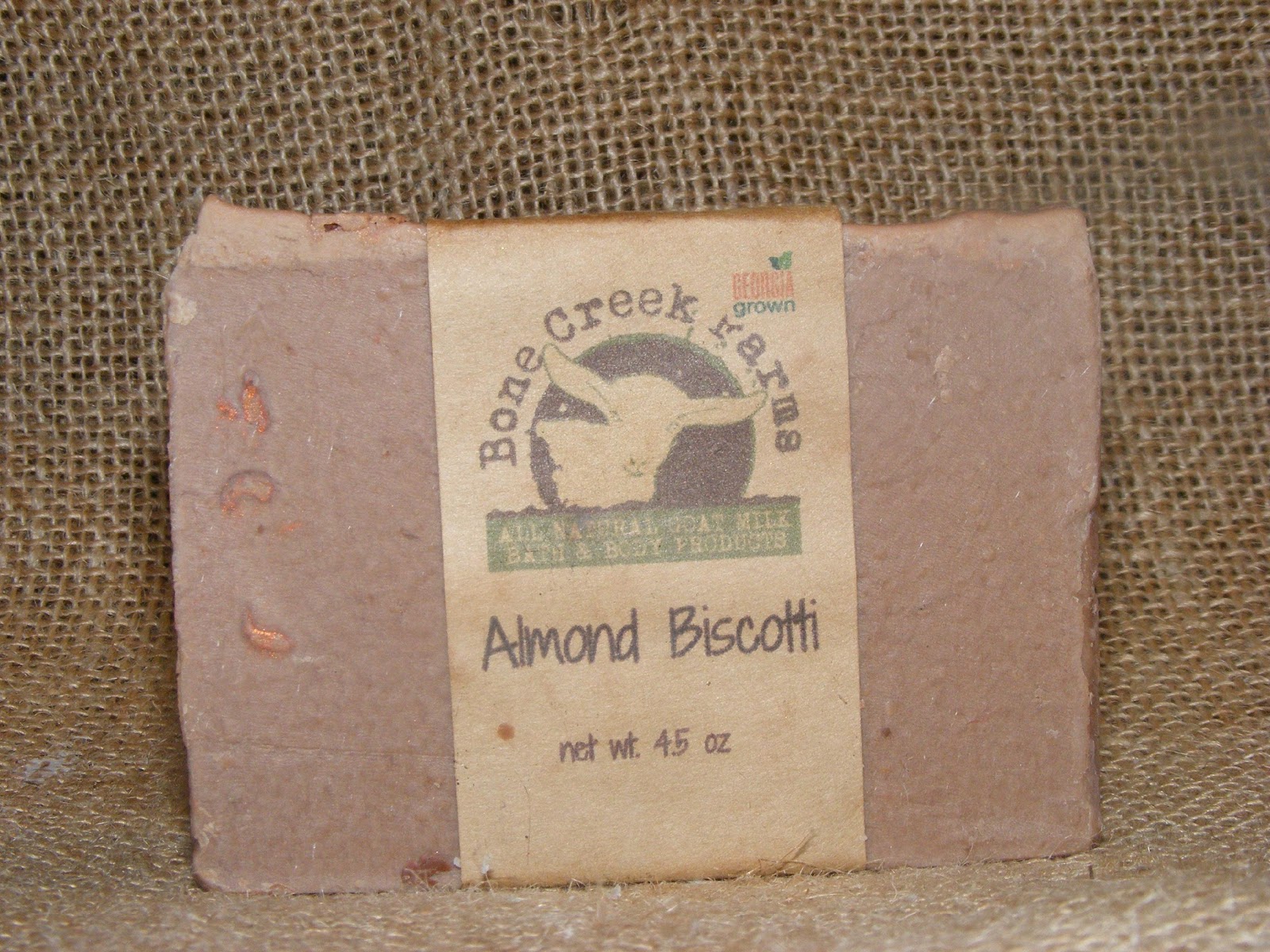 almondbiscotti Almond Biscotti soap bar from Bone Creek Farms, featuring a natural, earthy design and eco-friendly packaging. Weighs 4.5 ounces and emphasizes all-natural ingredients for skincare.